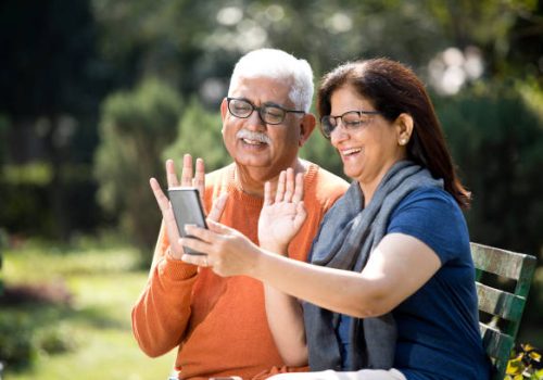 Senior couple on video call at park